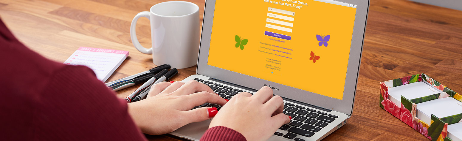 woman typing on laptop looking at the home page of School Annual Online