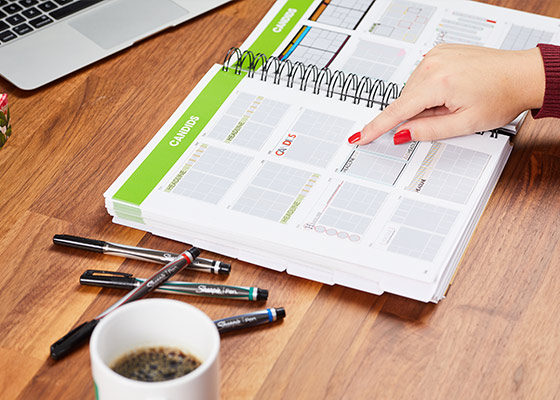 woman's finger with red painted nails points to template in the Manual